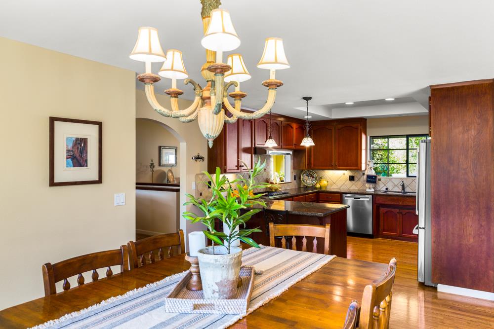 115 Santa Fe Ridge Aptos, CA 95003 - Photo 15 of 50 a view of a dining room with furniture a kitchen and chandelier