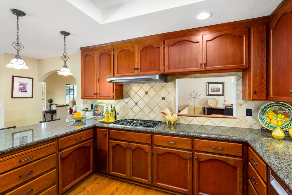 115 Santa Fe Ridge Aptos, CA 95003 - Photo 19 of 50 a kitchen with granite countertop stainless steel appliances a sink window and cabinets