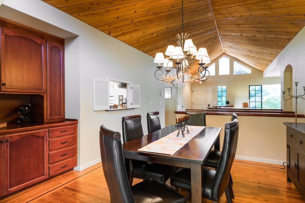 115 Santa Fe Ridge Aptos, CA 95003 - Photo 23 of 50 a view of a dining room with furniture and a chandelier