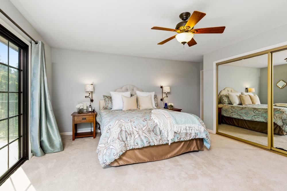 115 Santa Fe Ridge Aptos, CA 95003 - Photo 25 of 50 a bedroom with a bed and a chandelier