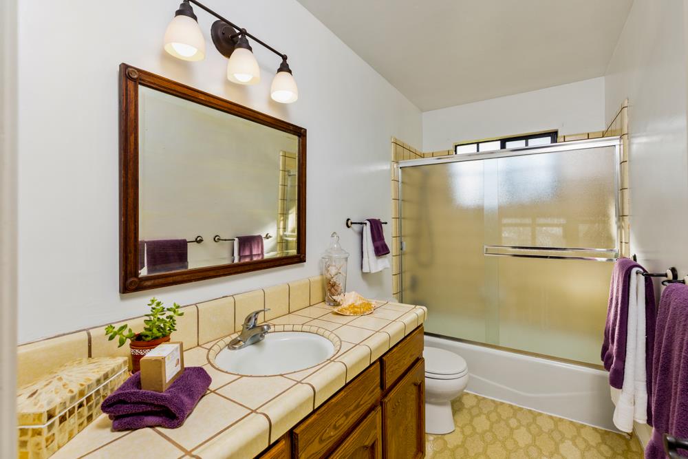 115 Santa Fe Ridge Aptos, CA 95003 - Photo 27 of 50 a bathroom with a granite countertop sink mirror and a shower
