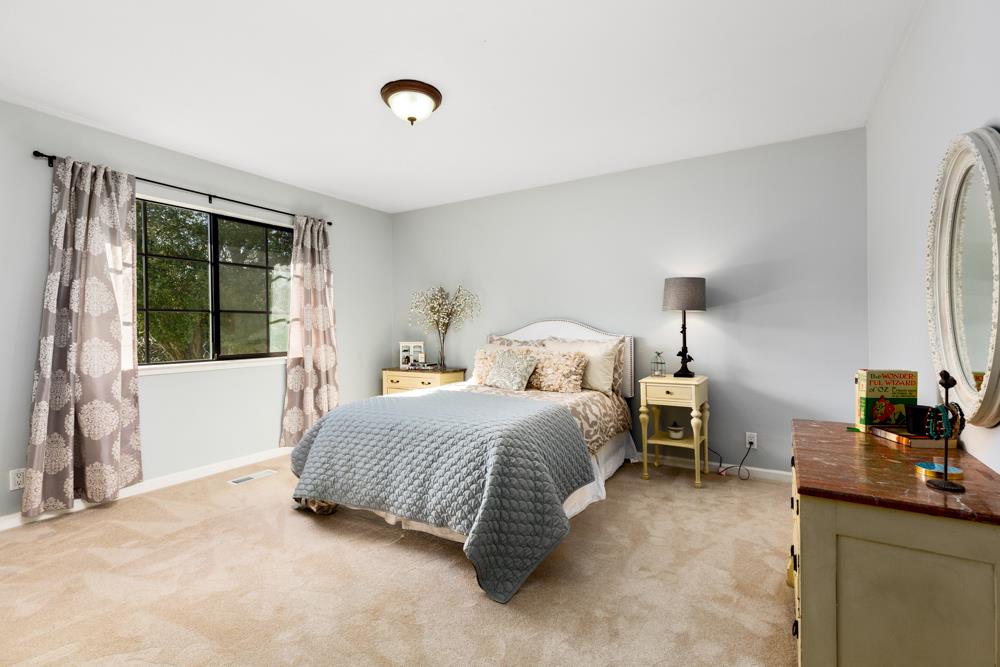 115 Santa Fe Ridge Aptos, CA 95003 - Photo 28 of 50 a bedroom with a bed and a dresser next to a window