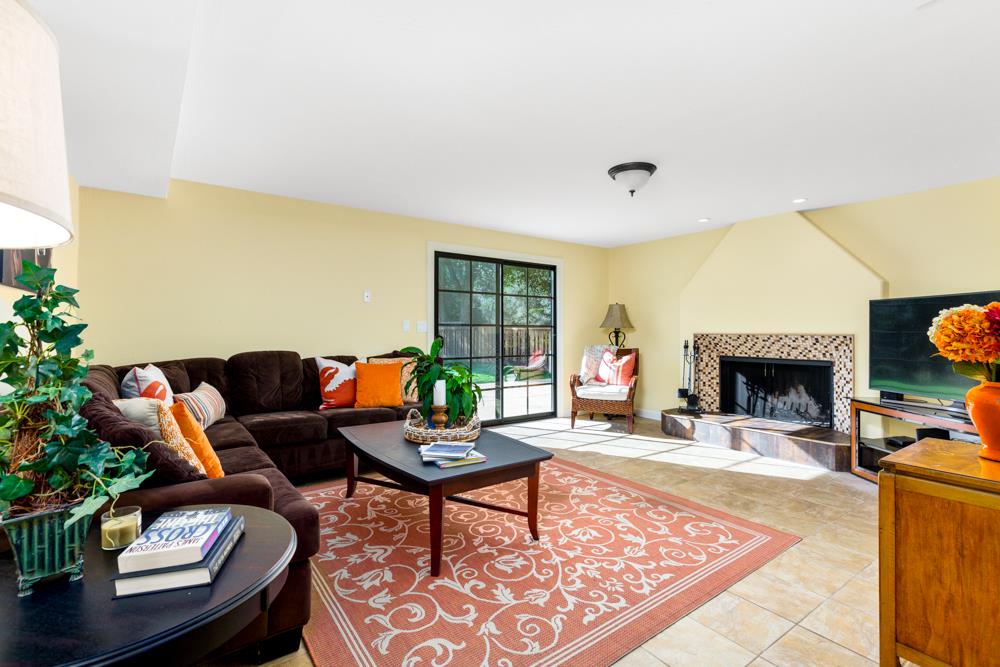 115 Santa Fe Ridge Aptos, CA 95003 - Photo 32 of 50 a living room with furniture a rug and a fireplace