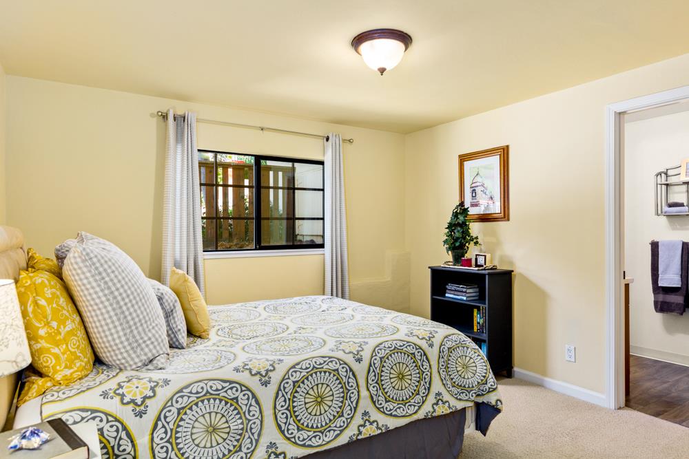115 Santa Fe Ridge Aptos, CA 95003 - Photo 33 of 50 a bedroom with a bed and dresser with mirror