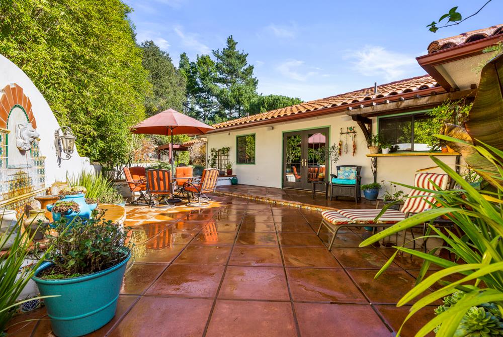 115 Santa Fe Ridge Aptos, CA 95003 - Photo 36 of 50 a view of a patio with table and chairs potted plants and large tree