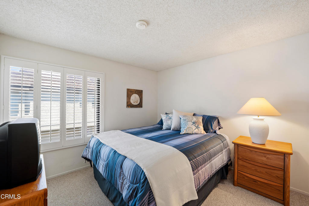 3310 Sunset Lane Oxnard, CA 93035 - Photo 23 of 29 a bedroom with a bed and a dresser next to a window