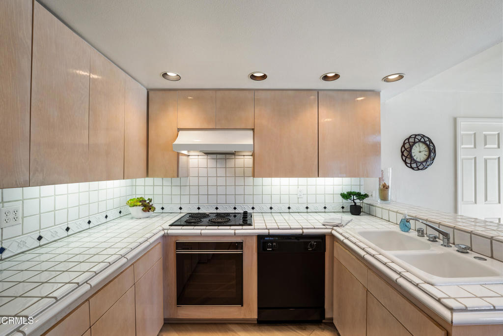 3310 Sunset Lane Oxnard, CA 93035 - Photo 10 of 29 a kitchen with a sink stove top oven and cabinets