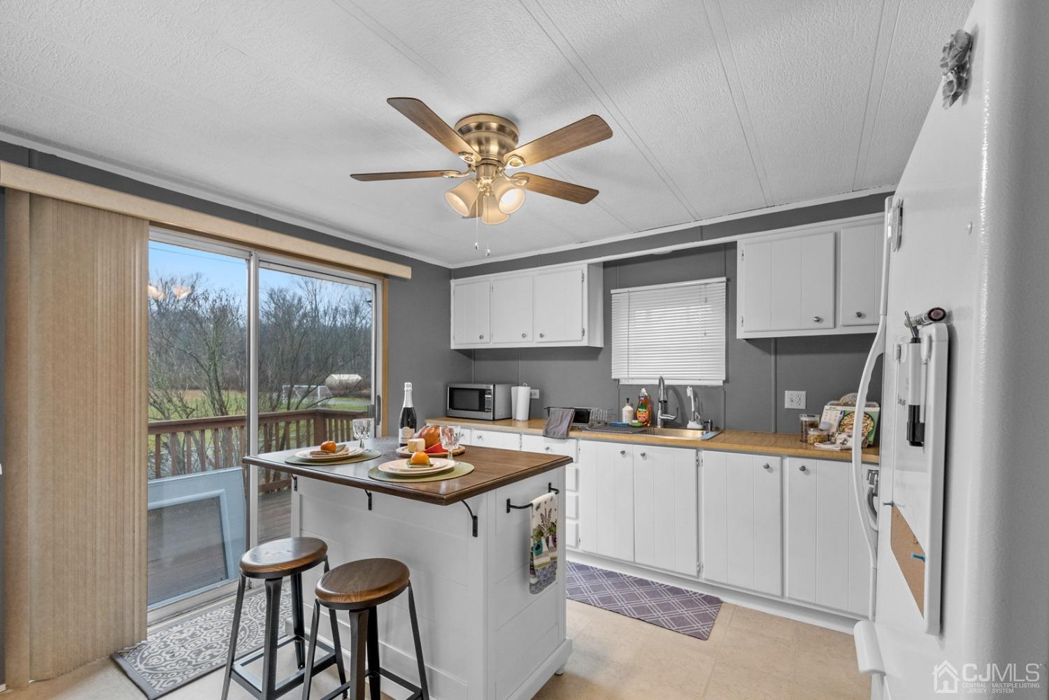 36 Whitman Road North Brunswick, NJ 08902 - Photo 2 of 31 a kitchen with a stove a refrigerator and a sink with cabinets