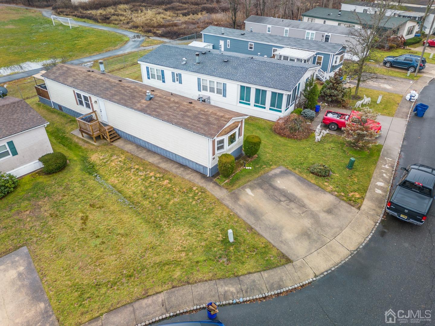 36 Whitman Road North Brunswick, NJ 08902 - Photo 24 of 31 an aerial view of a house with a garden and lake view