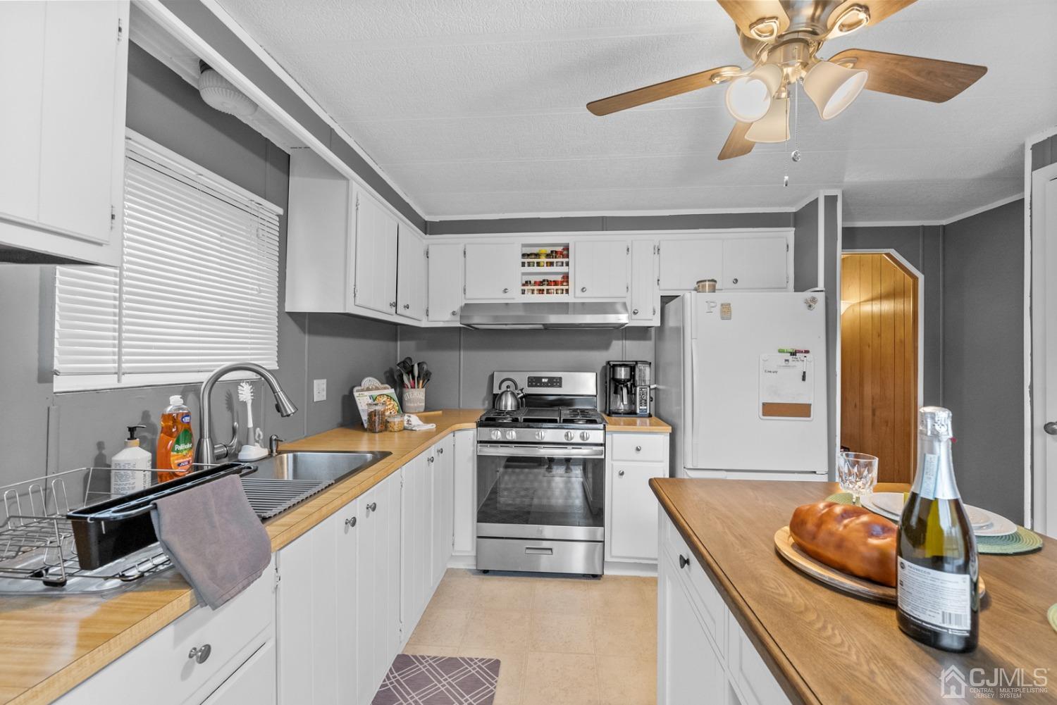 36 Whitman Road North Brunswick, NJ 08902 - Photo 3 of 31 a kitchen with stainless steel appliances granite countertop a sink and cabinets