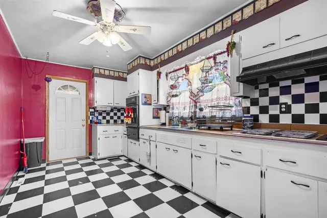 a kitchen with granite countertop stainless steel appliances a sink and cabinets