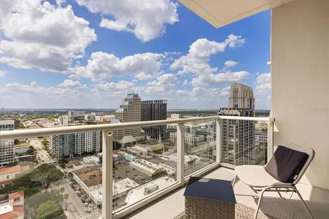 a view of a balcony with two chairs and a table
