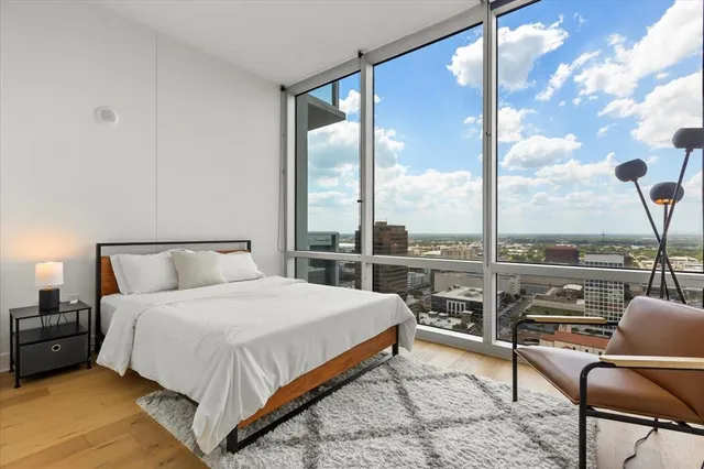 a bedroom with a bed couch and window
