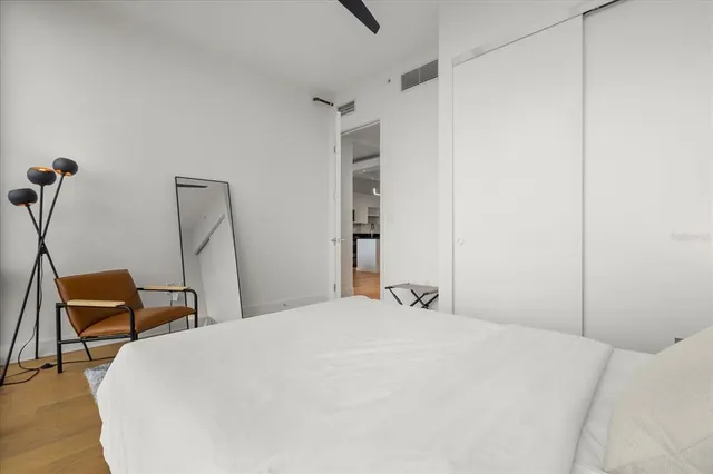 a bedroom with a bed and chair