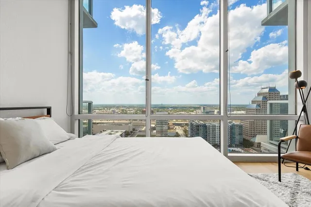 a bedroom with a large bed and a balcony view