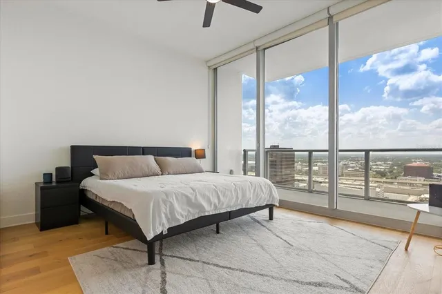 a bedroom with a large bed and a large window