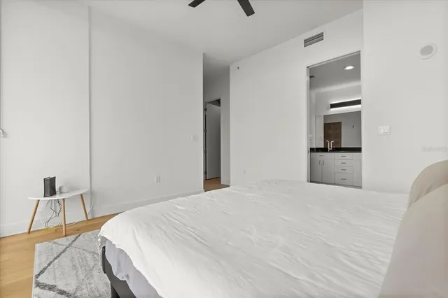 a bedroom with a bed and a chair