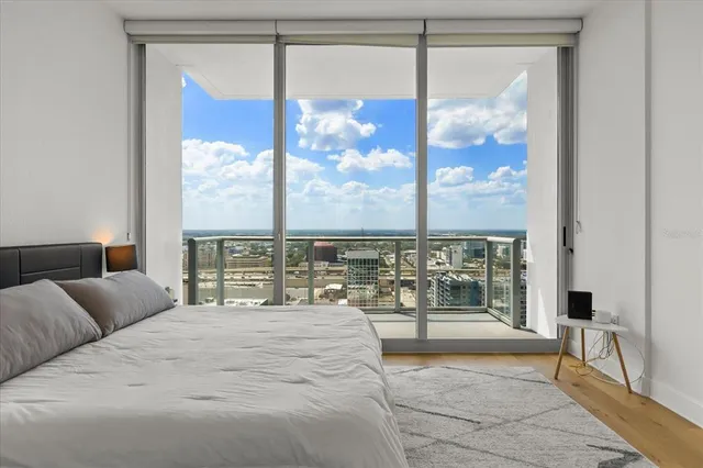 a bedroom with a large bed and a window