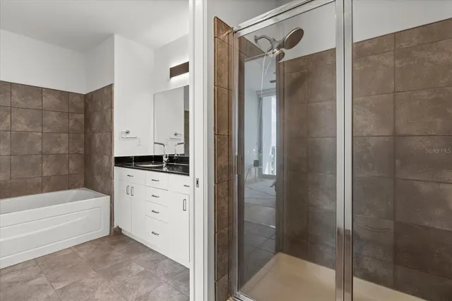 a bathroom with a bathtub and a shower