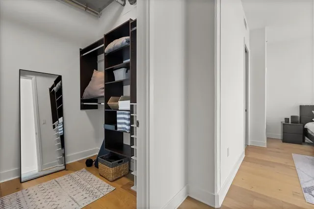 a view of walk in closet with clothes and shoes