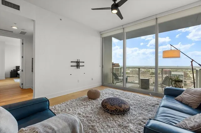 a living room with furniture and a floor to ceiling window