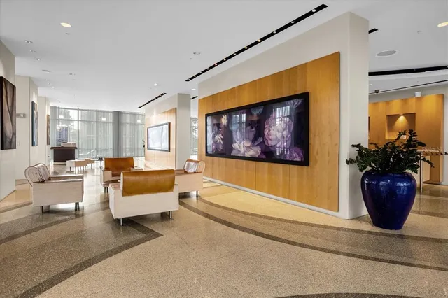 a living room with furniture and a potted plant