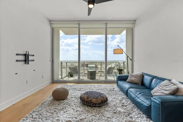 a living room with furniture and a floor to ceiling window