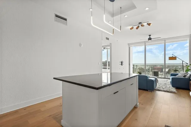 a kitchen with a sink cabinets and wooden floor