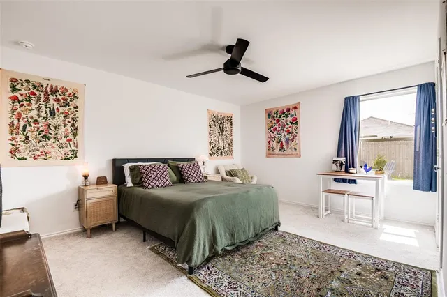 a living room with a bed furniture and a large window