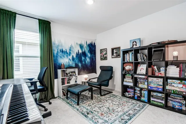 a living room with furniture and a book shelf