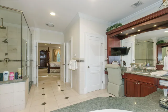 a bathroom with a double vanity sink a mirror and shower