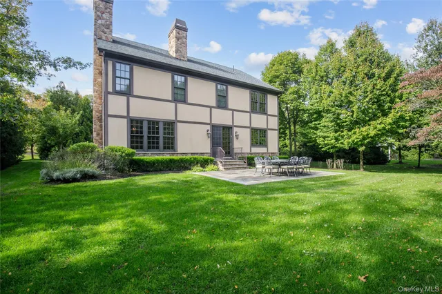 a house view with swimming pool and garden space