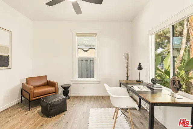 a view of a livingroom with furniture wooden floor and a window
