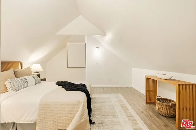 a bedroom with a bed and a mirror