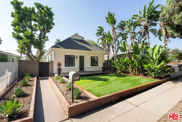 a view of a house with backyard sitting area and garden