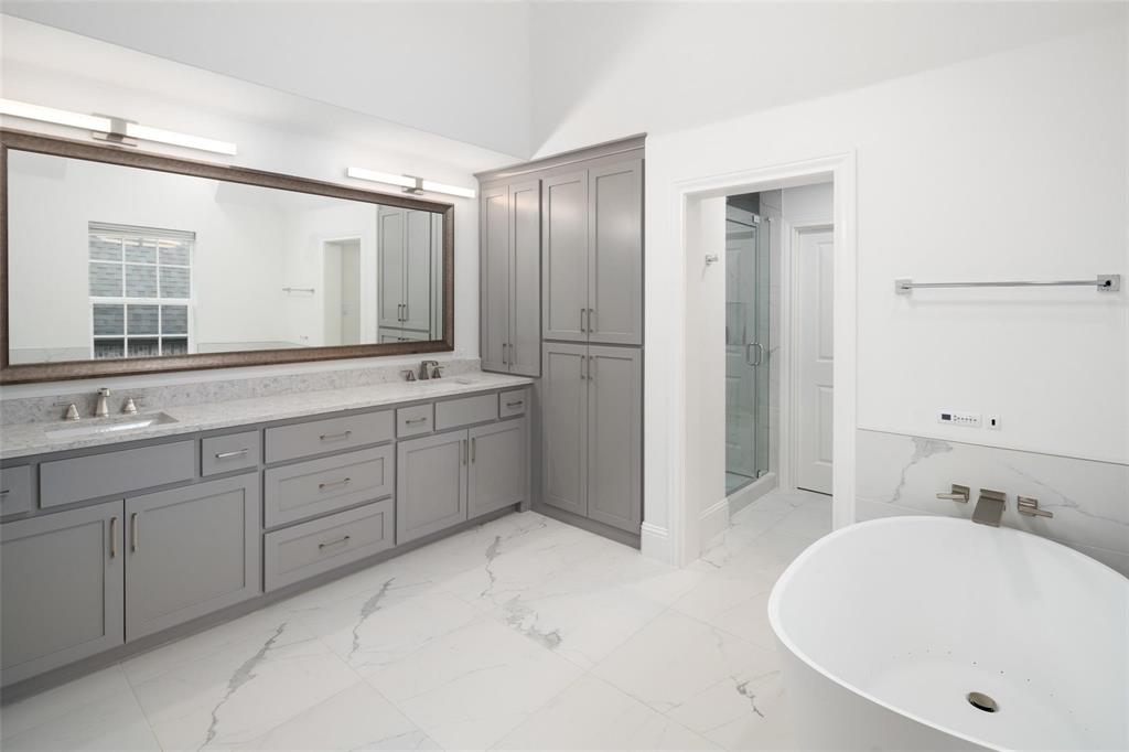 818 Brett Drive Allen, TX 75013 - Photo 23 of 38 a bathroom with a tub sink and mirror