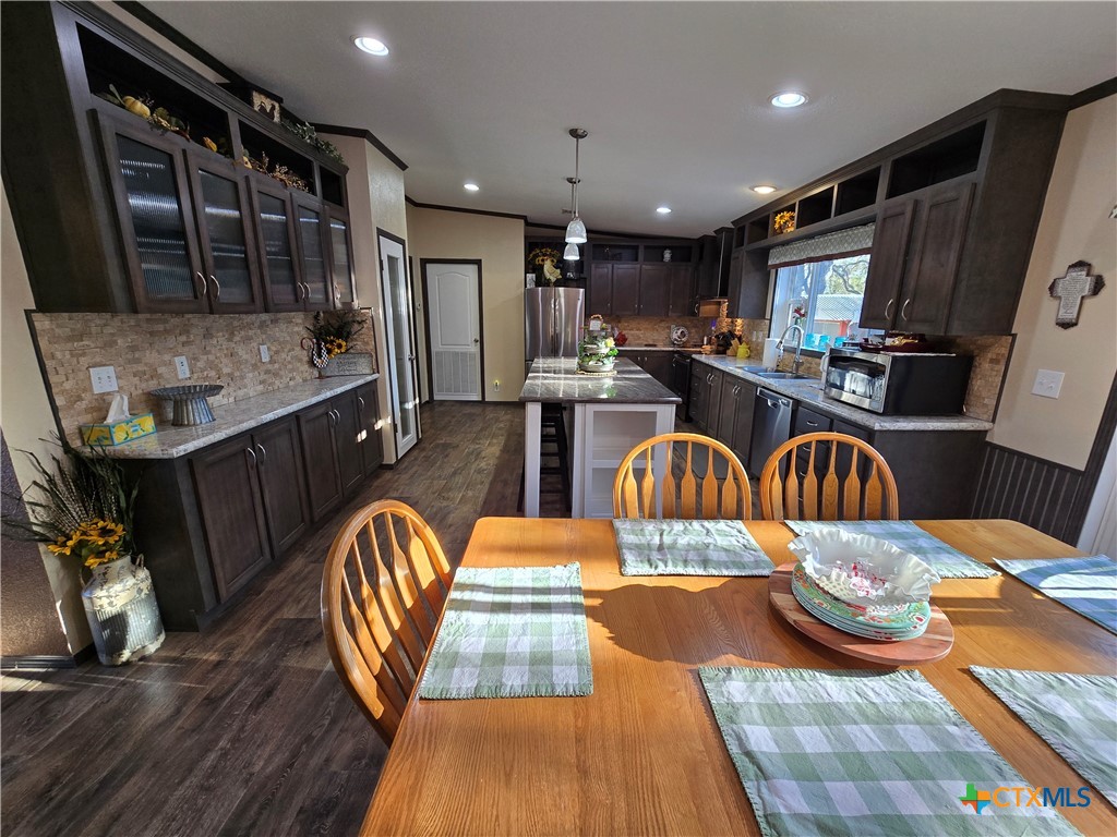 390-400 North Fawn Ridge Drive Leander, TX 78641 - Photo 11 of 48 a kitchen with stainless steel appliances granite countertop a sink and wooden cabinets