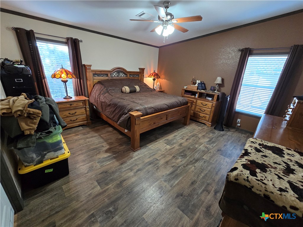 390-400 North Fawn Ridge Drive Leander, TX 78641 - Photo 15 of 48 a bedroom with a bed and wooden floor