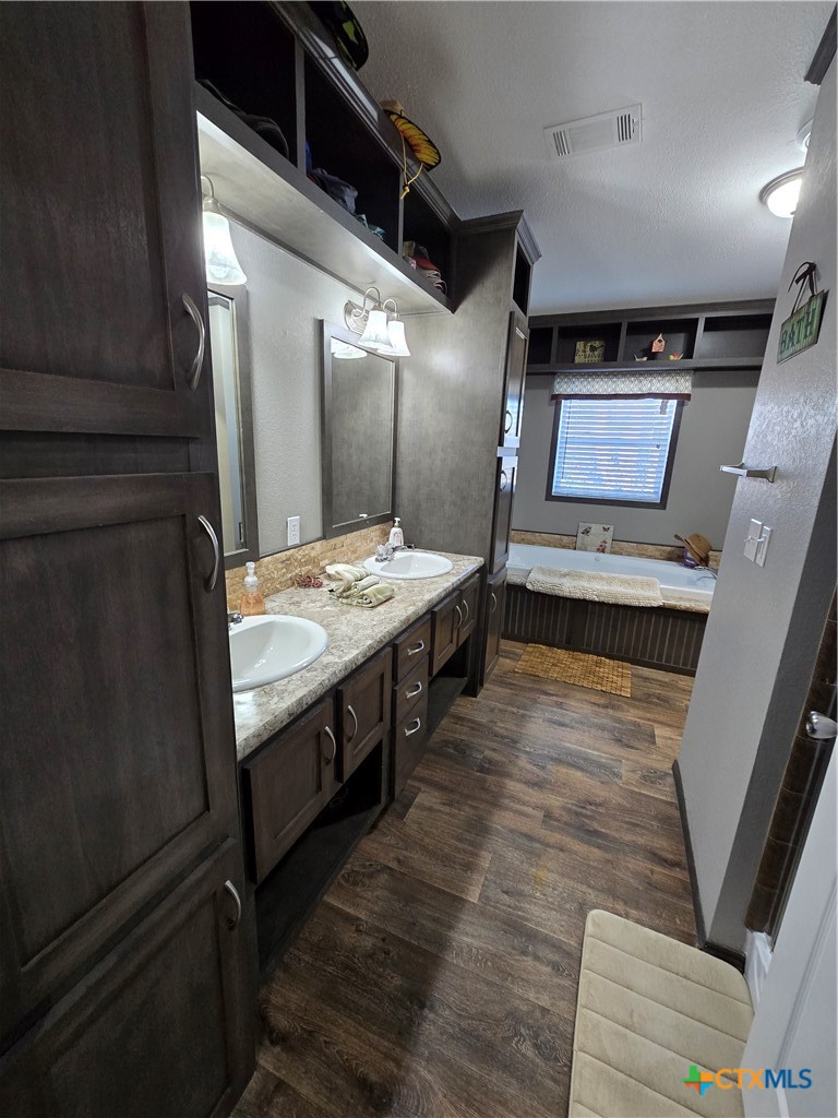 390-400 North Fawn Ridge Drive Leander, TX 78641 - Photo 17 of 48 a bathroom with double vanity and a mirror