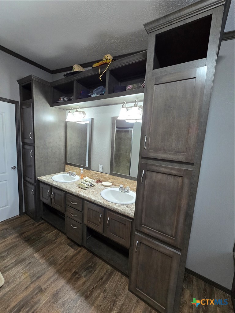 390-400 North Fawn Ridge Drive Leander, TX 78641 - Photo 18 of 48 a kitchen with stainless steel appliances granite countertop a refrigerator and a wooden floor