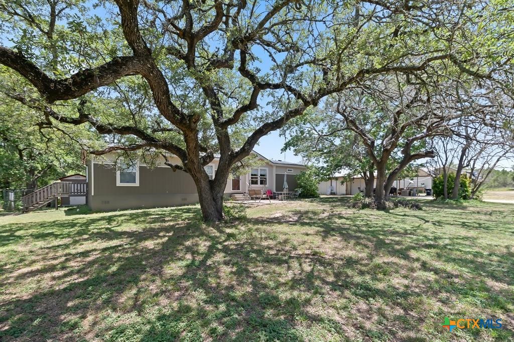 390-400 North Fawn Ridge Drive Leander, TX 78641 - Photo 2 of 48 a tree in the middle of a yard