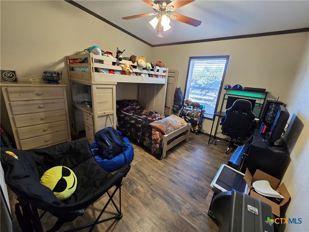 390-400 North Fawn Ridge Drive Leander, TX 78641 - Photo 23 of 48 a bedroom with bed and wooden floor