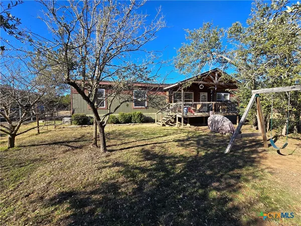 a view of a patio with table and chairs with wooden floor and fence