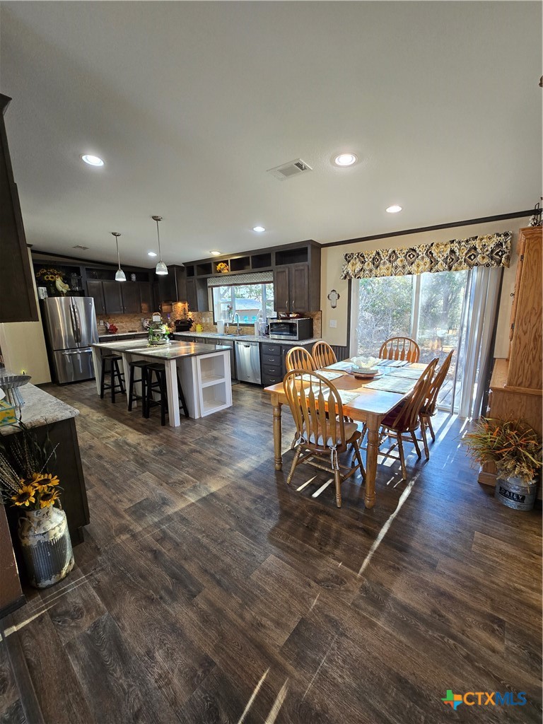 390-400 North Fawn Ridge Drive Leander, TX 78641 - Photo 10 of 48 a large kitchen with a table and chairs