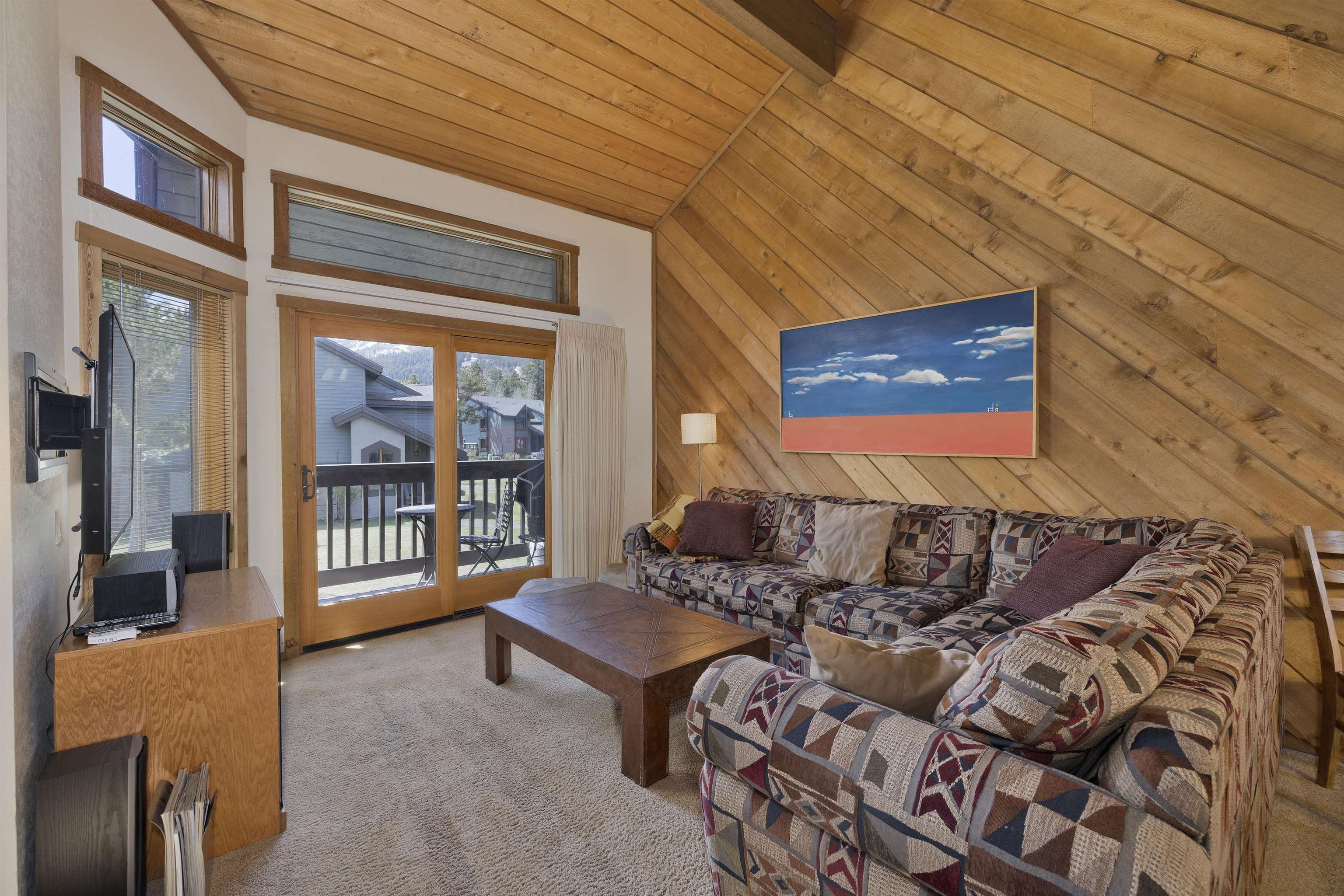 417 Snowcreek Road, Unit 417 Mammoth Lakes, CA 93546 - Photo 13 of 31 Vaulted wood-paneled ceilings and walls complement the wood-framed glass sliding doors