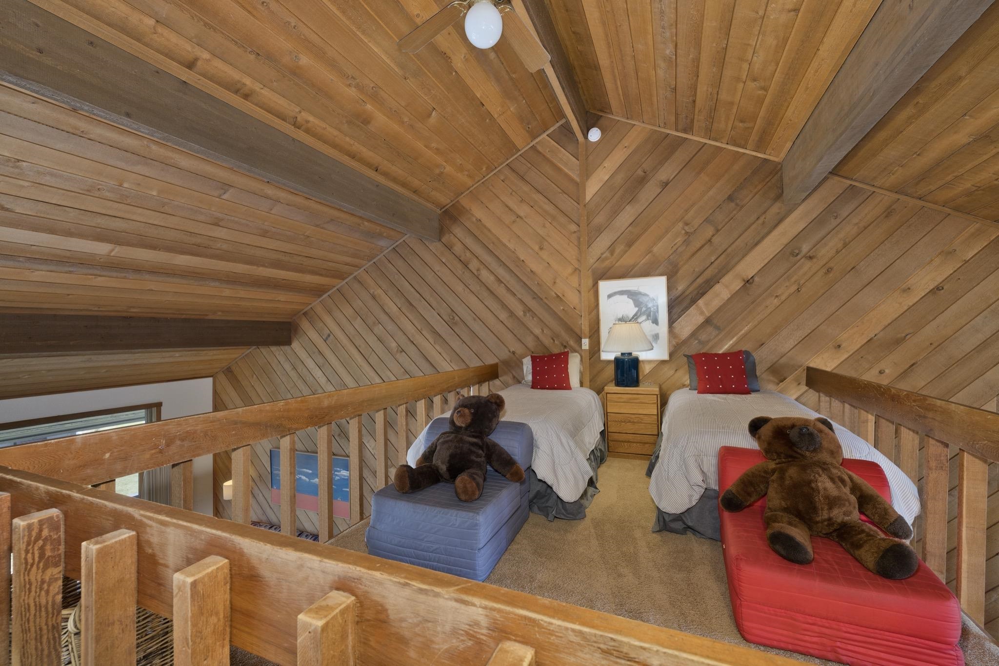 417 Snowcreek Road, Unit 417 Mammoth Lakes, CA 93546 - Photo 16 of 31 Loft space featuring extensive wood-finish wall and ceiling paneling