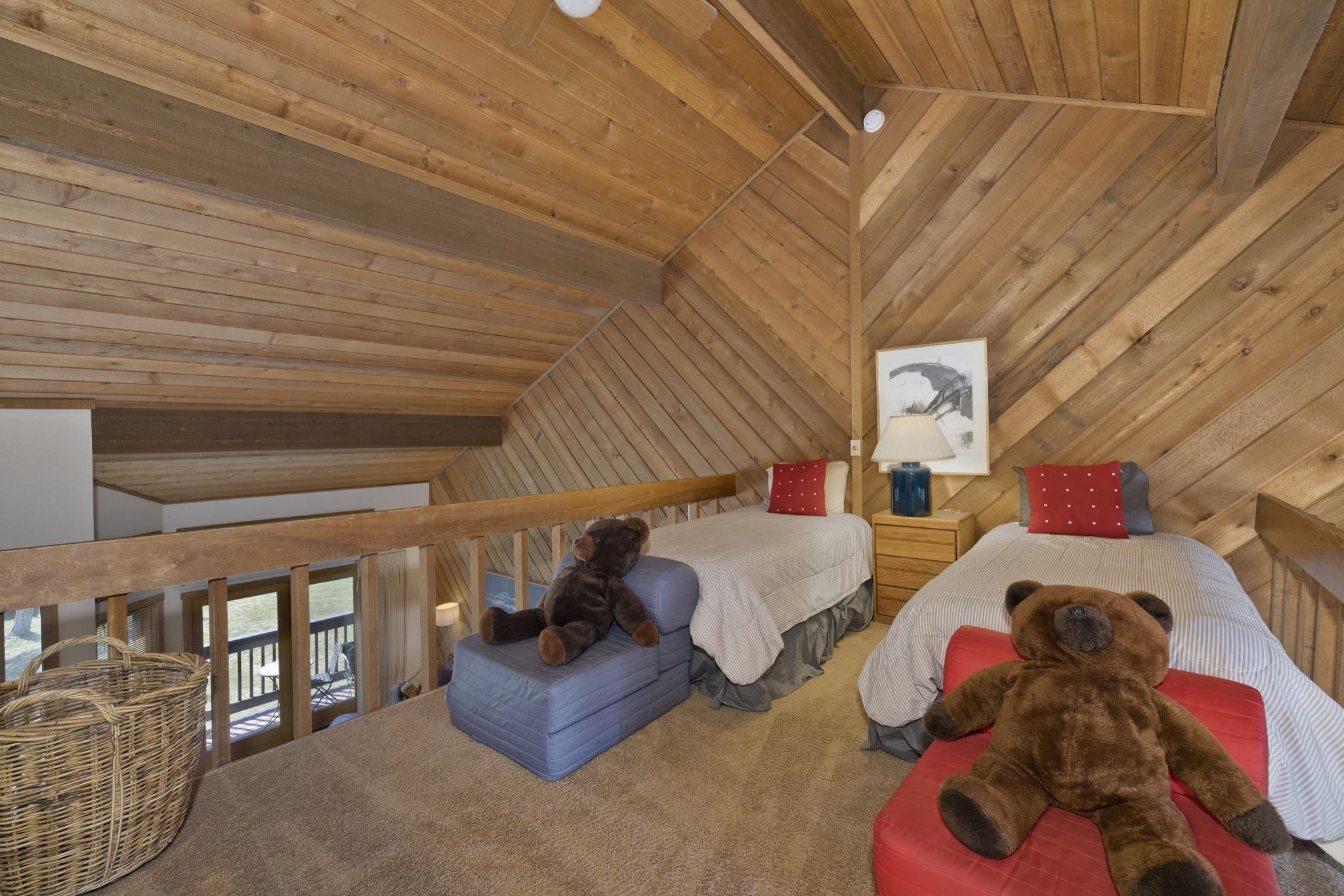 417 Snowcreek Road, Unit 417 Mammoth Lakes, CA 93546 - Photo 17 of 31 Carpeted loft space featuring natural wood plank walls and ceiling, exposed wooden beams, and a wood