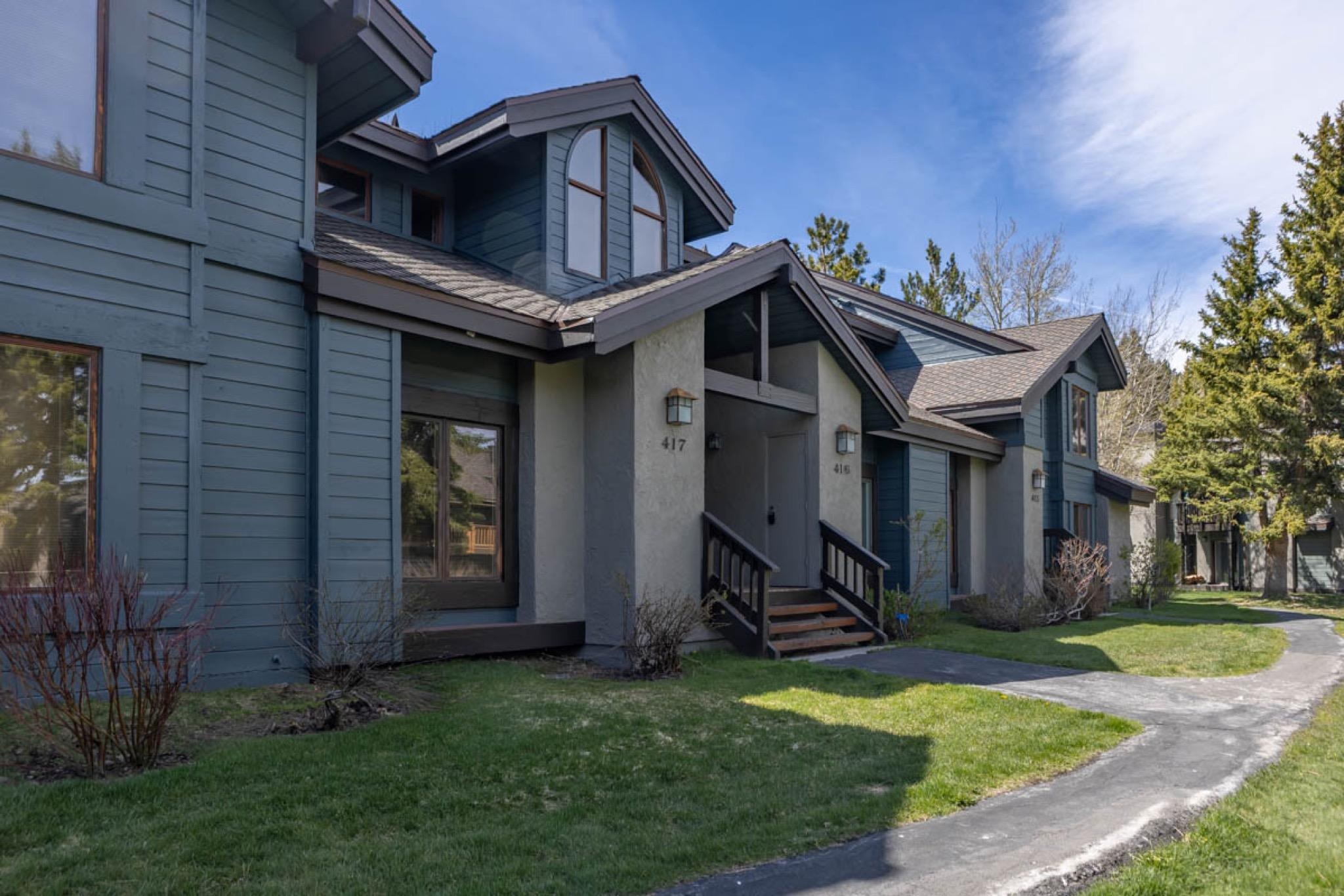 417 Snowcreek Road, Unit 417 Mammoth Lakes, CA 93546 - Photo 2 of 31 Multi-level townhouse exterior featuring blue horizontal siding and stucco accents