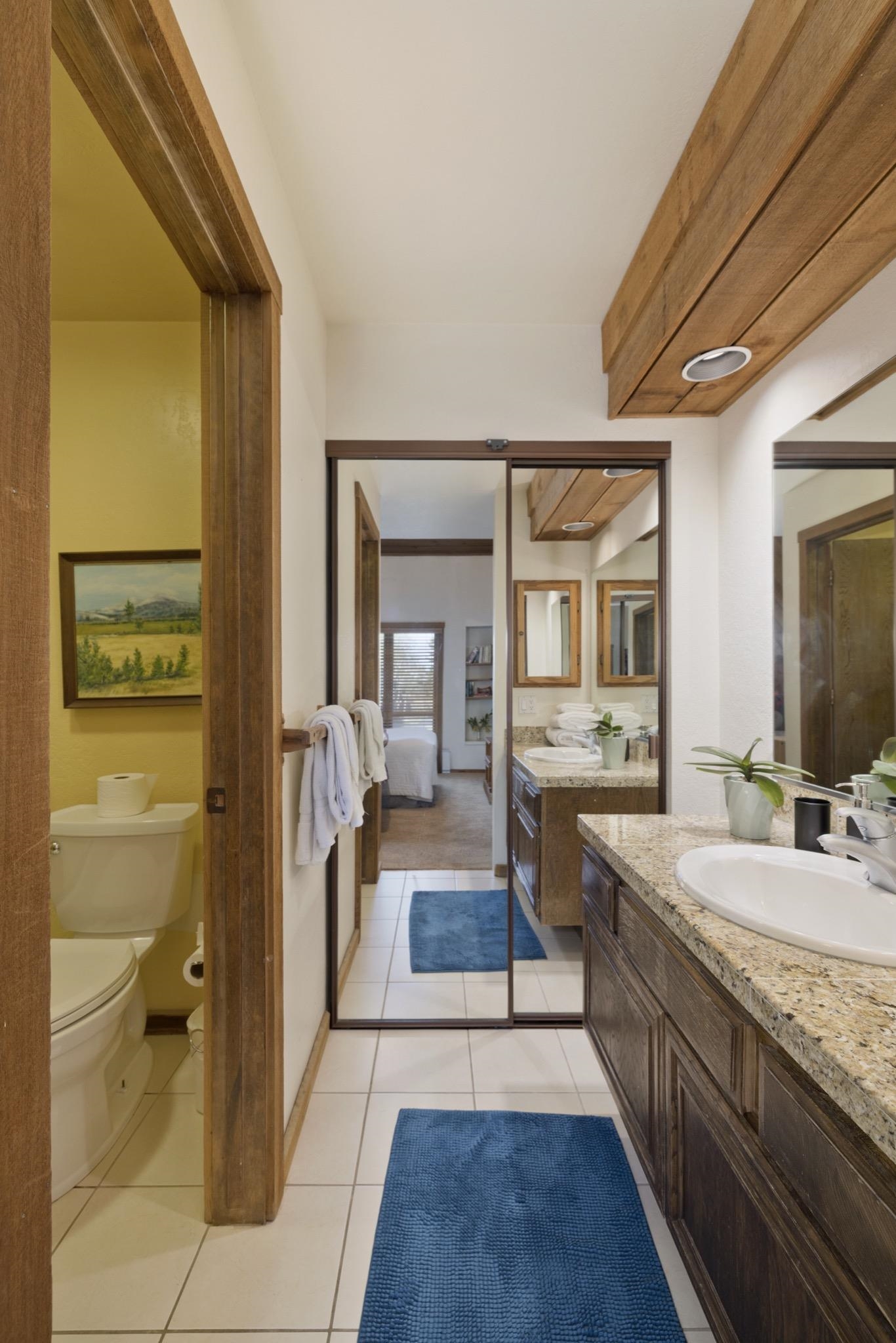 417 Snowcreek Road, Unit 417 Mammoth Lakes, CA 93546 - Photo 21 of 31 Bathroom vanity with an undermount sink, granite countertop, and dark wood cabinetry