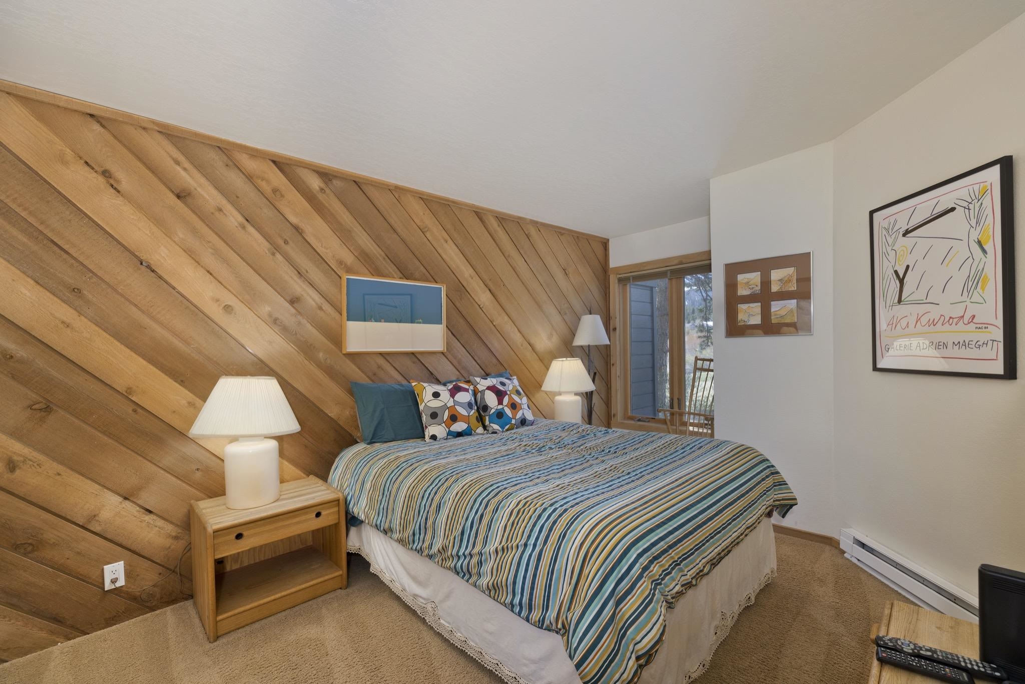 417 Snowcreek Road, Unit 417 Mammoth Lakes, CA 93546 - Photo 24 of 31 Diagonal wood paneling accent wall featuring built-in bedside tables with integrated lamps